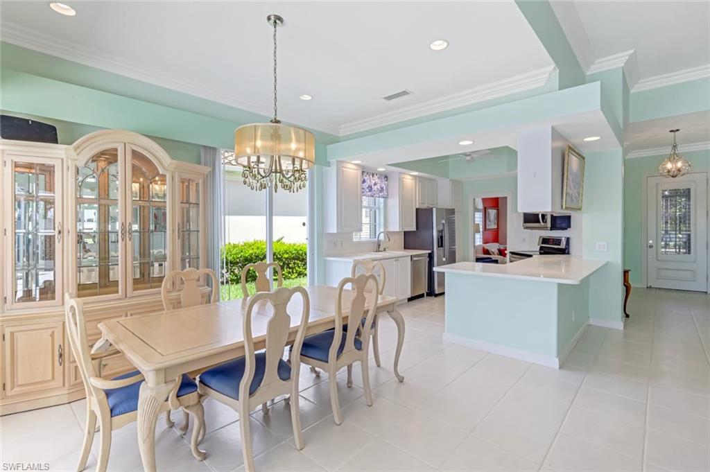 3794 Whidbey Way Naples, FL 34119 - Photo 15 of 46 a dining room with furniture a chandelier and window