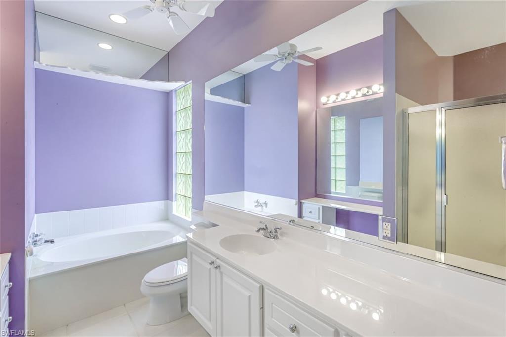 3794 Whidbey Way Naples, FL 34119 - Photo 20 of 46 a bathroom with a bathtub shower sink and toilet