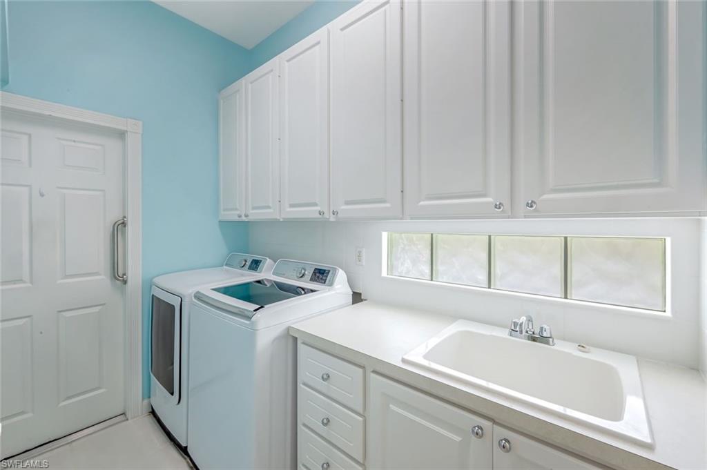 3794 Whidbey Way Naples, FL 34119 - Photo 24 of 46 a bathroom with a sink and cabinets