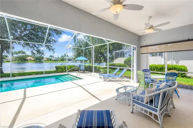 a living room with patio furniture and a floor to ceiling window