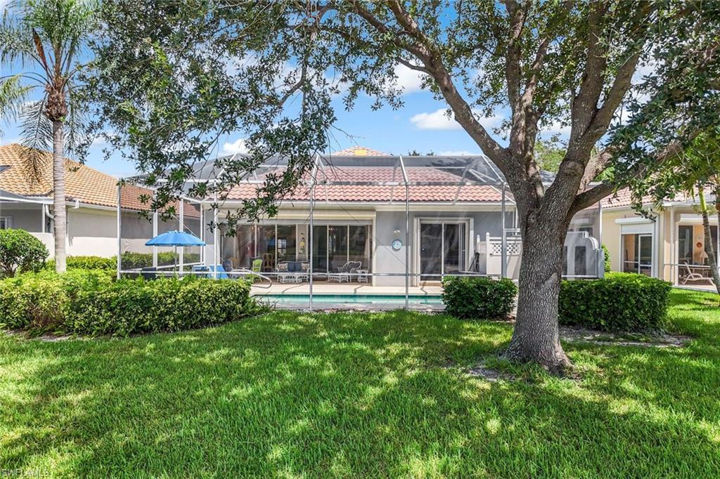 3794 Whidbey Way Naples, FL 34119 - Photo 32 of 46 a front view of a house with yard patio and green space