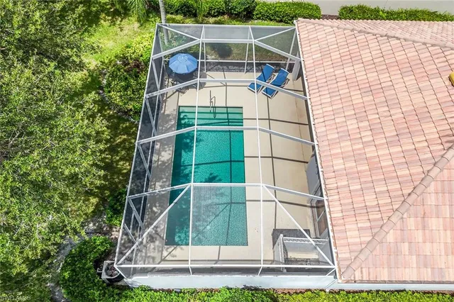 an aerial view of residential houses with outdoor space and trees