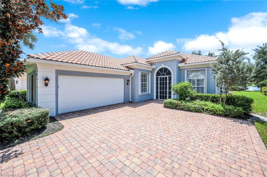 3794 Whidbey Way Naples, FL 34119 - Photo 4 of 46 a front view of a house with a yard