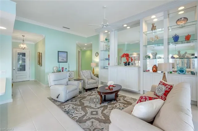 a living room with furniture and a view of kitchen