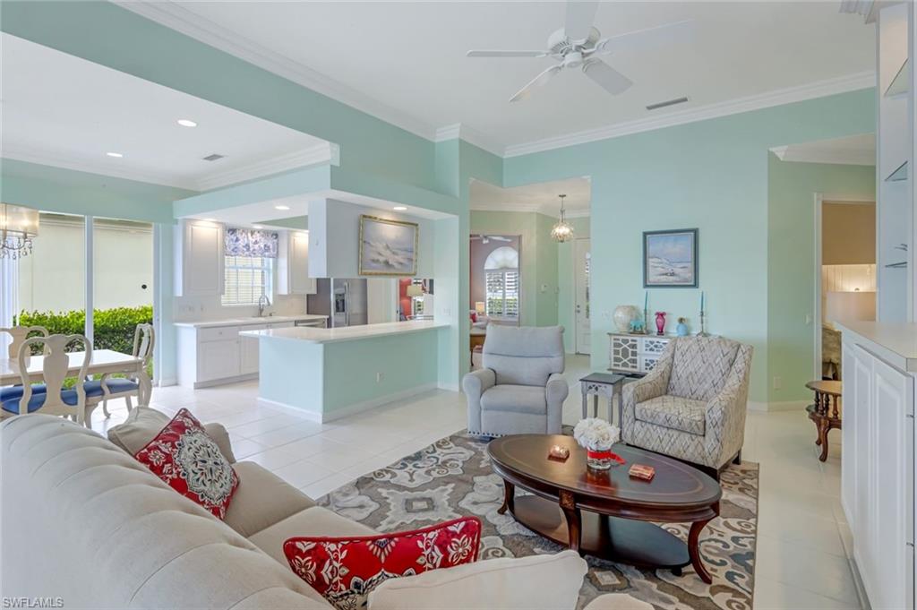 3794 Whidbey Way Naples, FL 34119 - Photo 9 of 46 a living room with furniture and a view of kitchen