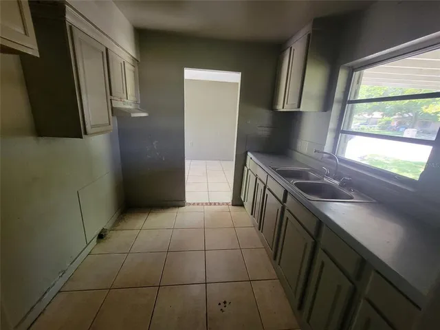 a kitchen with a sink a stove and refrigerator