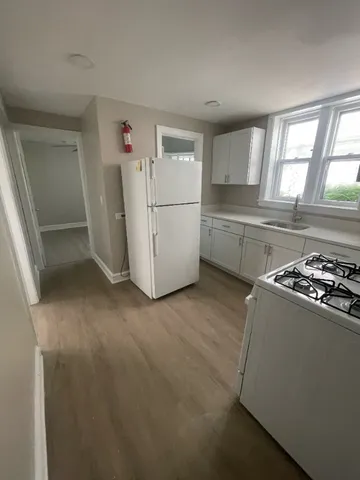 a room with a stove and a refrigerator