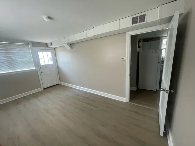 a white toilet sitting in a bathroom next to a window