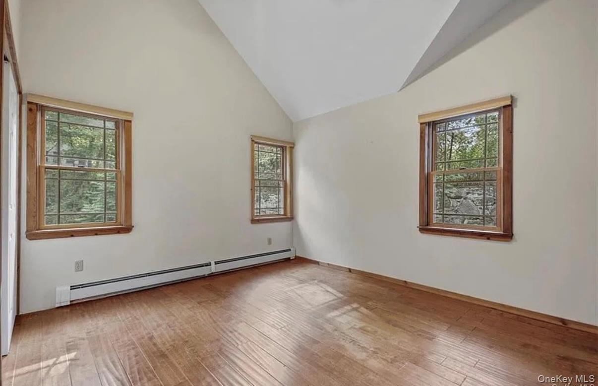11 Oakdale Road Putnam Valley, NY 10579 - Photo 15 of 31 a view of an empty room with wooden floor and a window
