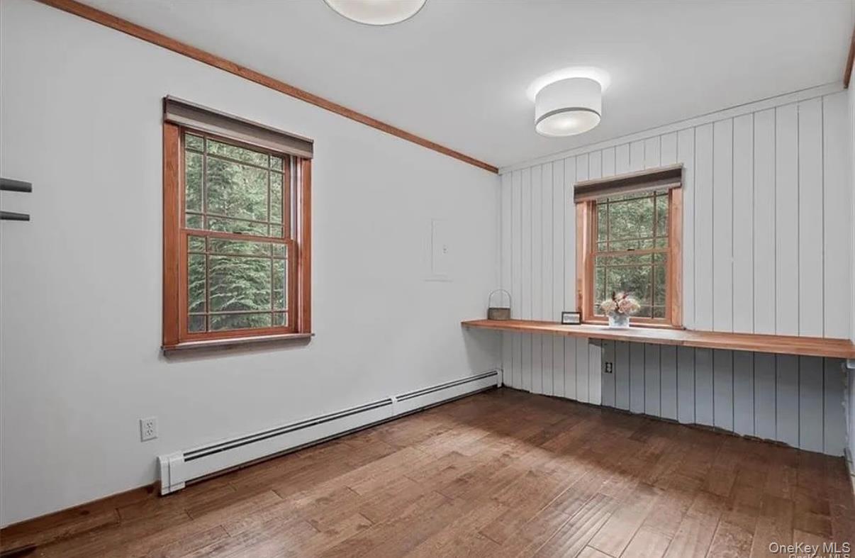 11 Oakdale Road Putnam Valley, NY 10579 - Photo 17 of 31 a view of an empty room with a window and wooden floor