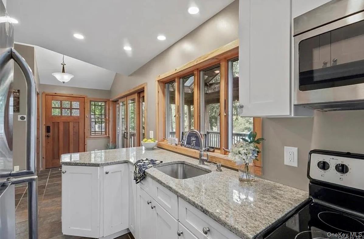 11 Oakdale Road Putnam Valley, NY 10579 - Photo 4 of 31 a kitchen with a stove a sink and a refrigerator