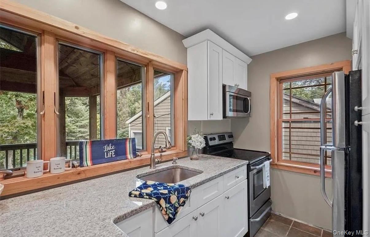 11 Oakdale Road Putnam Valley, NY 10579 - Photo 6 of 31 a kitchen with a stove a sink and a refrigerator