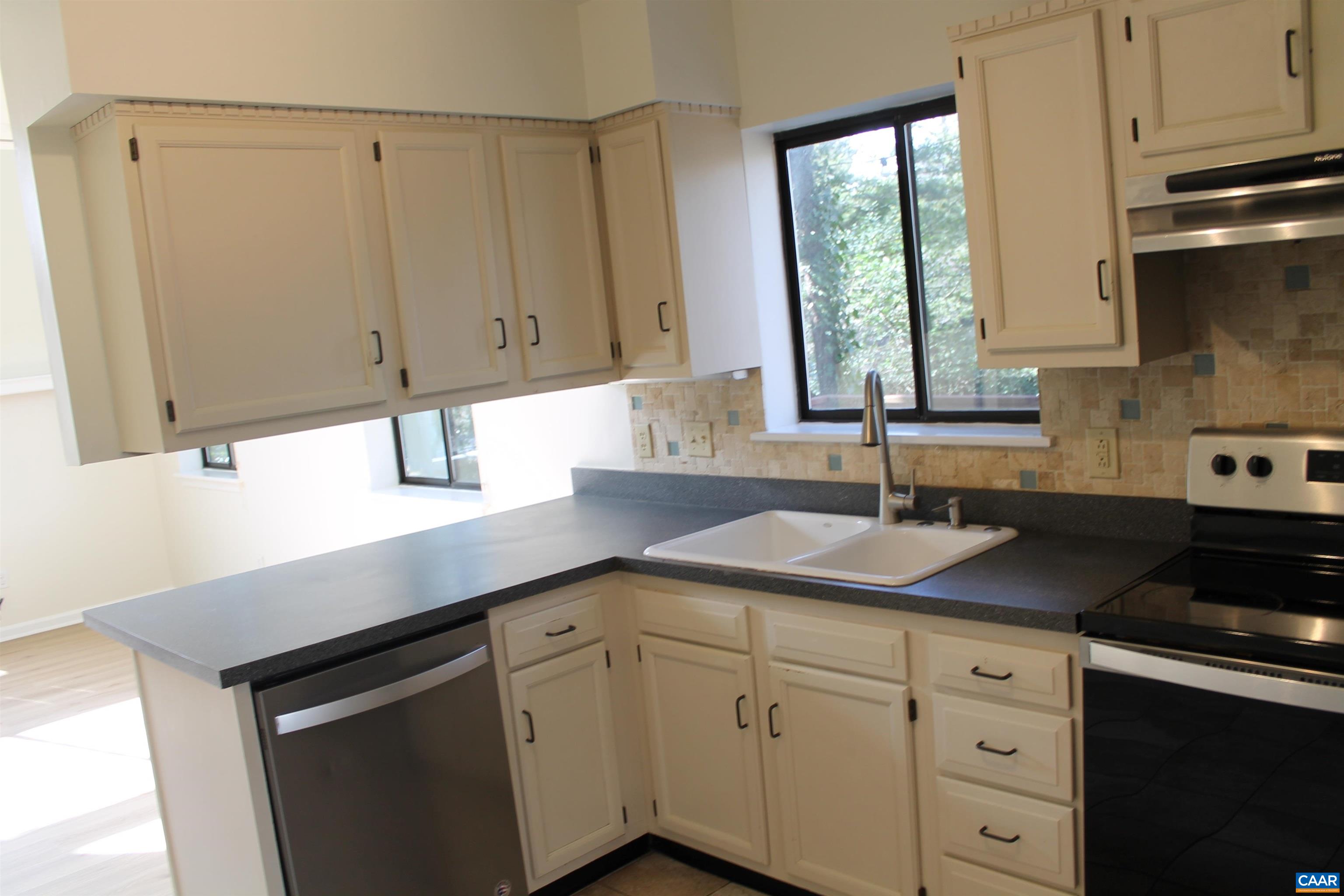 118 Mill Creek Drive Charlottesville, VA 22902 - Photo 2 of 30 a kitchen with a sink cabinets and window