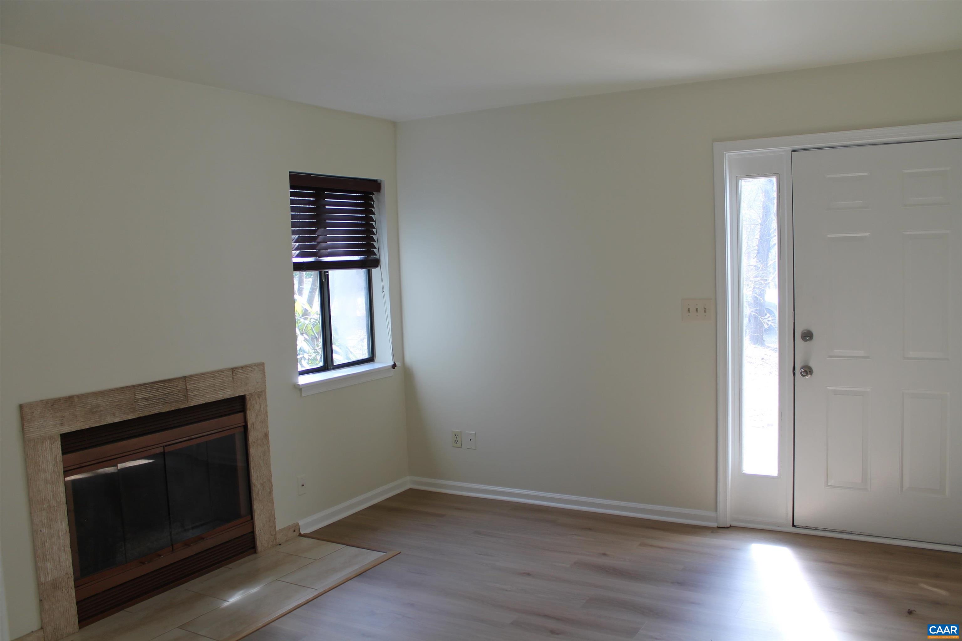118 Mill Creek Drive Charlottesville, VA 22902 - Photo 9 of 30 a view of an empty room with wooden floor and a window