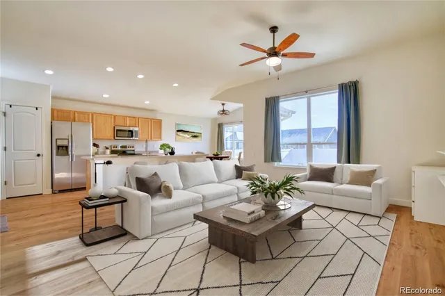 a living room with furniture and kitchen view