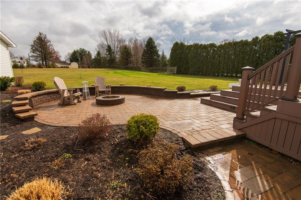 25 Stinedurf Road West Middlesex, PA 16159 - Photo 6 of 25 VIEW OF PAVER PATIO WITH FIRE PIT WITH KNEE WALL, ENHANCED WITH MULCH & PLANTINGS.