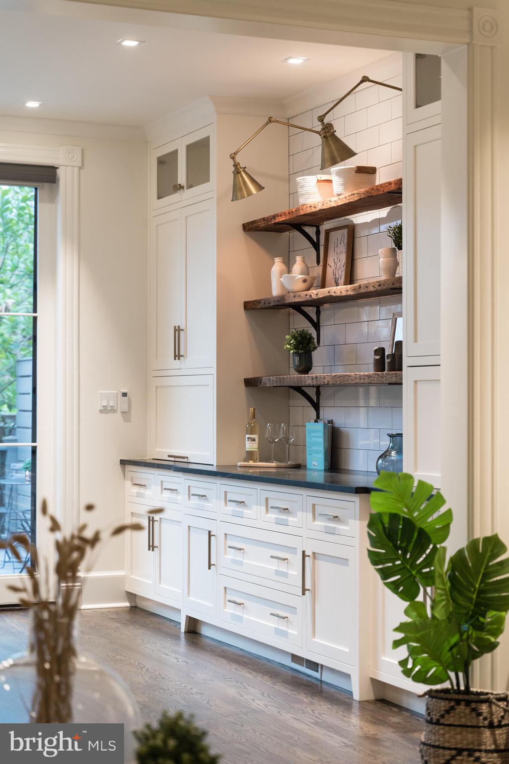 133 13th Street Northeast Washington, DC 20002 - Photo 6 of 41 a kitchen with white cabinets and a potted plant