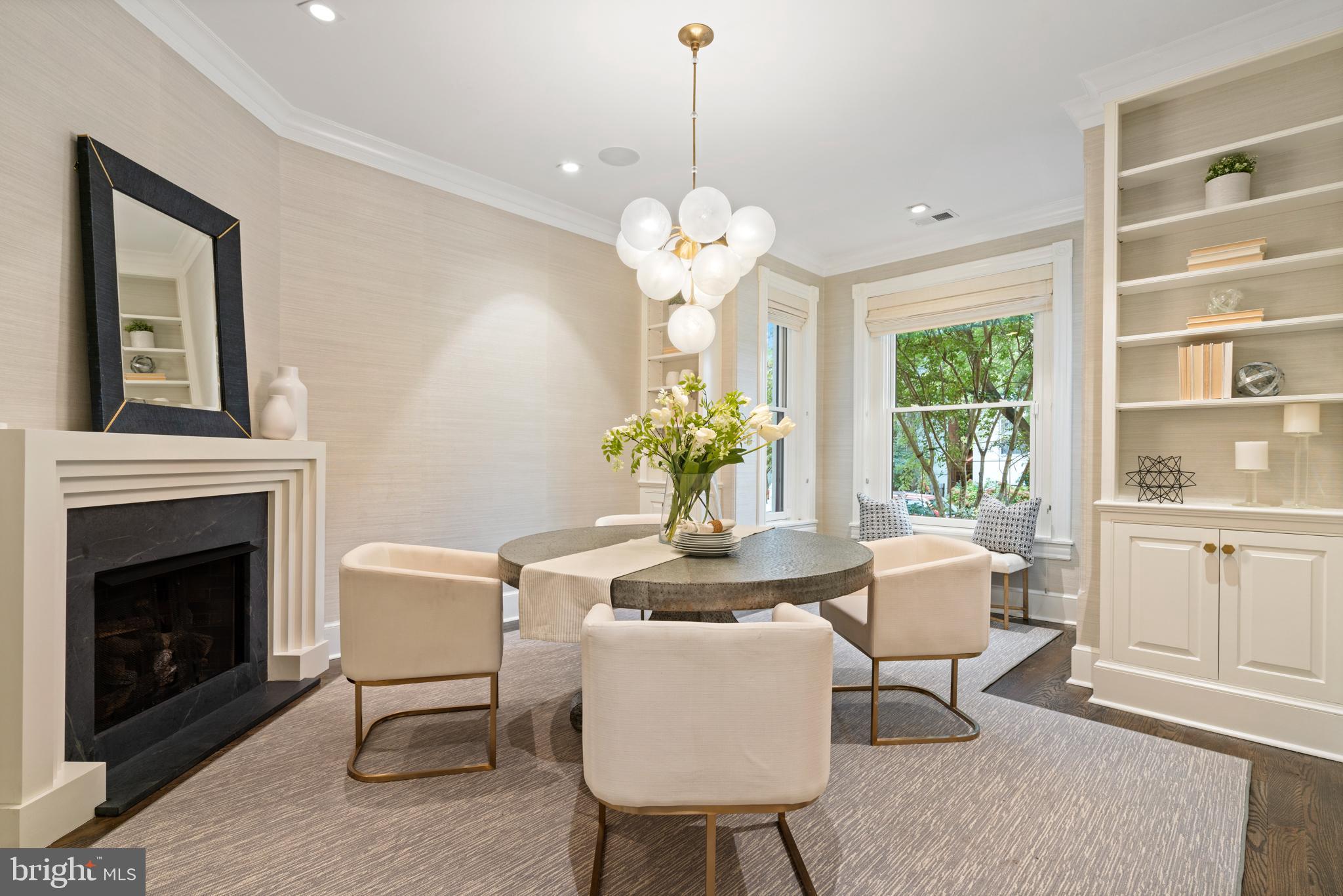 133 13th Street Northeast Washington, DC 20002 - Photo 10 of 41 a dining room with furniture a fireplace and a chandelier