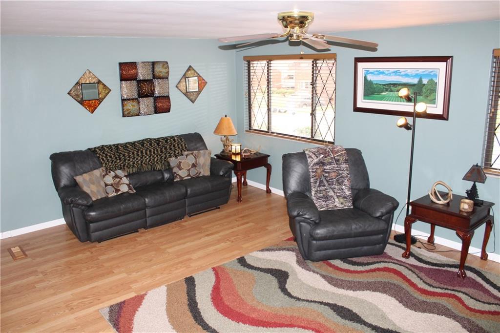 960 Lindsay Road Carnegie, PA 15106 - Photo 2 of 24 Livingroom with laminate wood flooring, ceiling fan and windows for plenty of natural light is open to the dining area and kitchen.