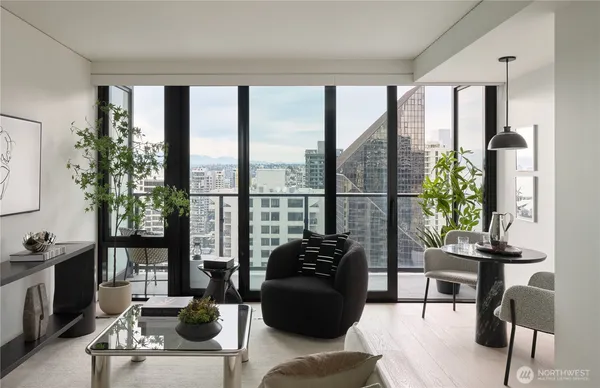 a living room with furniture and floor to ceiling windows