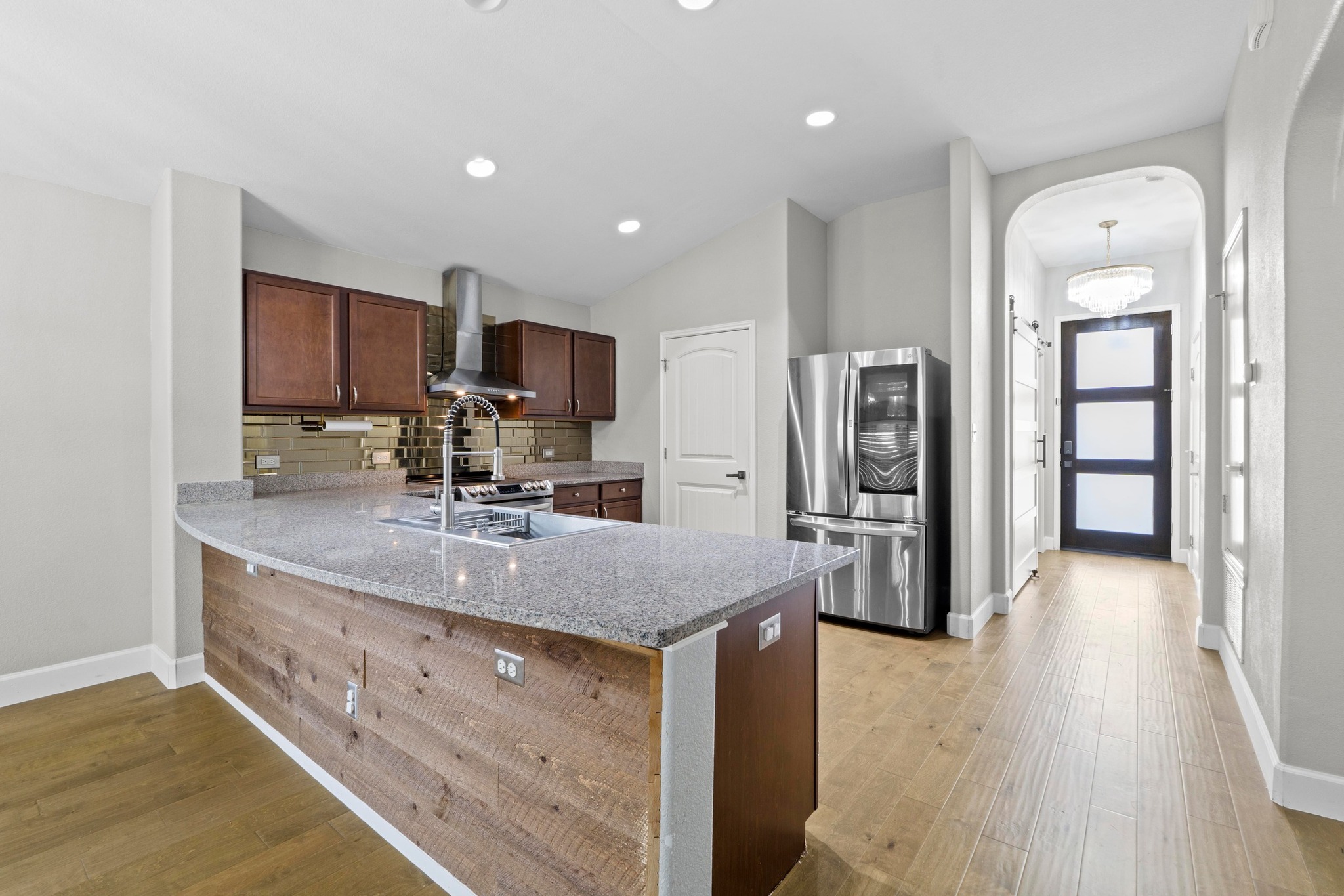 19004 Mangan Way Pflugerville, TX 78660 - Photo 12 of 38 The elegant granite countertops wrap around to a spacious peninsula, providing ample workspace and a perfect spot for casual dining.