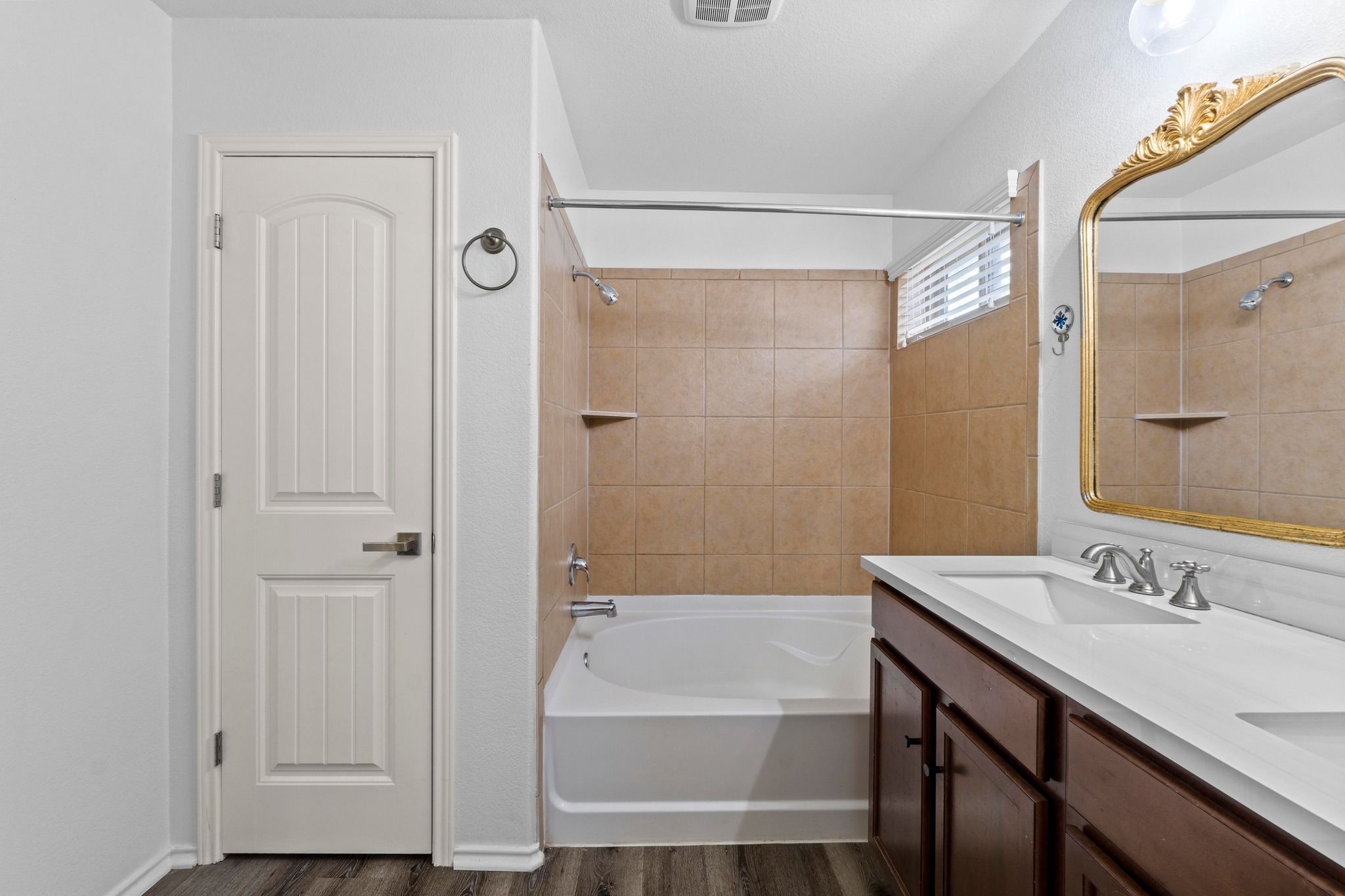 19004 Mangan Way Pflugerville, TX 78660 - Photo 21 of 38 The primary bathroom includes a spacious soaking tub and a clean, tiled shower surround. This bright and functional space offers the perfect blend of luxury and convenience.