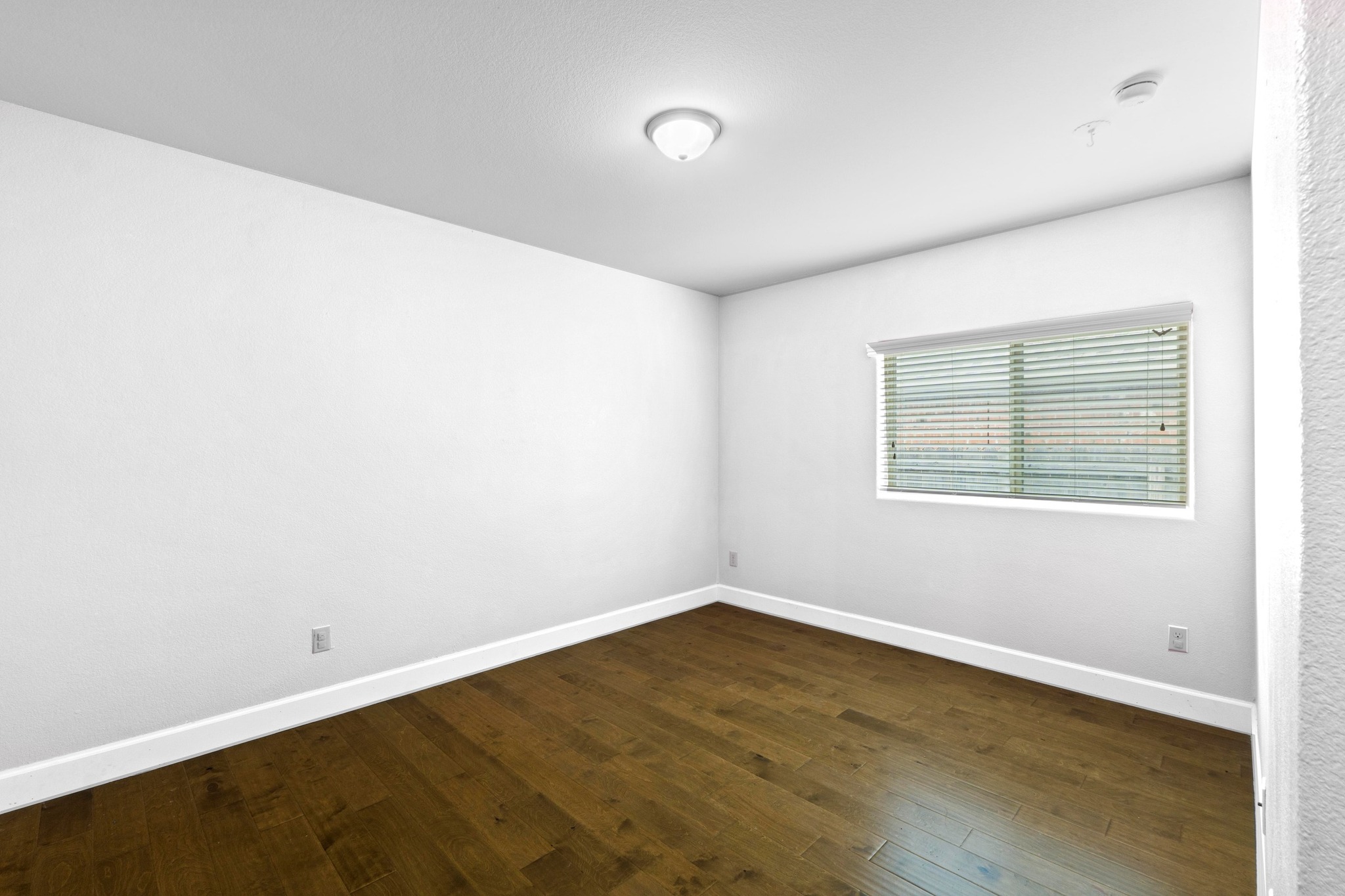 19004 Mangan Way Pflugerville, TX 78660 - Photo 26 of 38 Another nicely sized bedroom offers clean lines and upgraded flooring. This room provides plenty of space for a full bedroom set or can serve as a quiet home office.