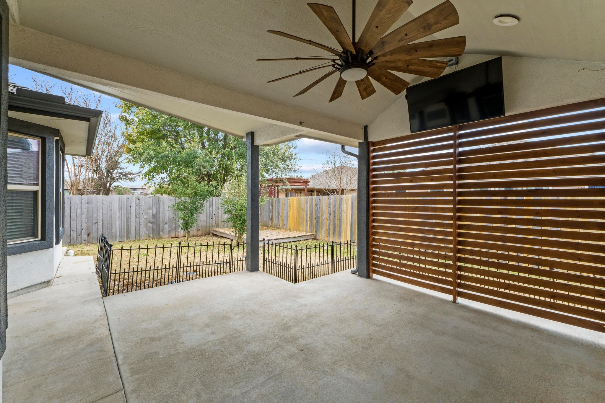 19004 Mangan Way Pflugerville, TX 78660 - Photo 29 of 38 Enjoy a view of your fully fenced backyard from the comfort of the shade. The secure fencing and low-maintenance lawn make this a great space for pets and play in a peaceful setting.