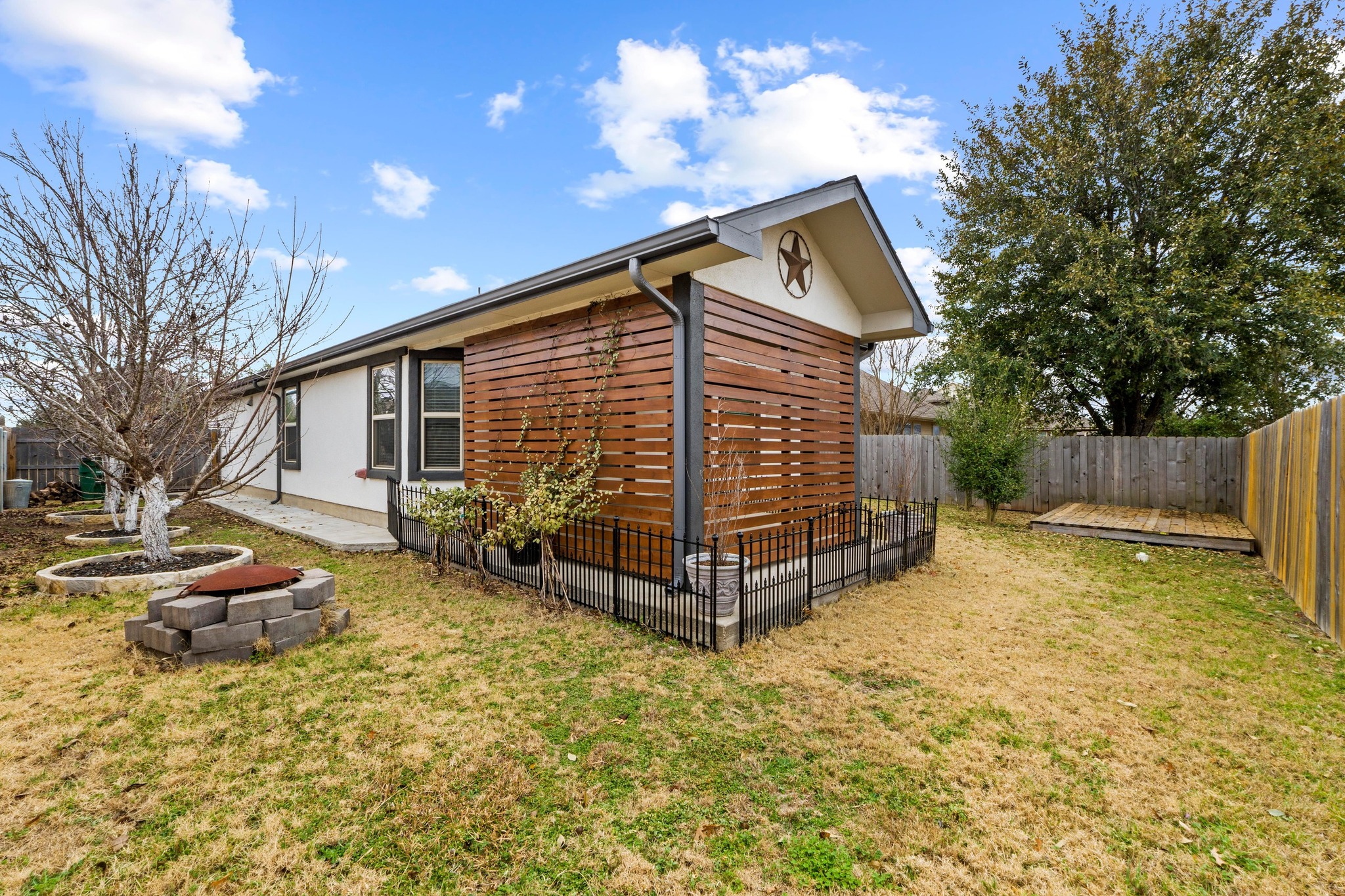 19004 Mangan Way Pflugerville, TX 78660 - Photo 32 of 38 A decorative wrought-iron fence detail separates the patio from the yard.
