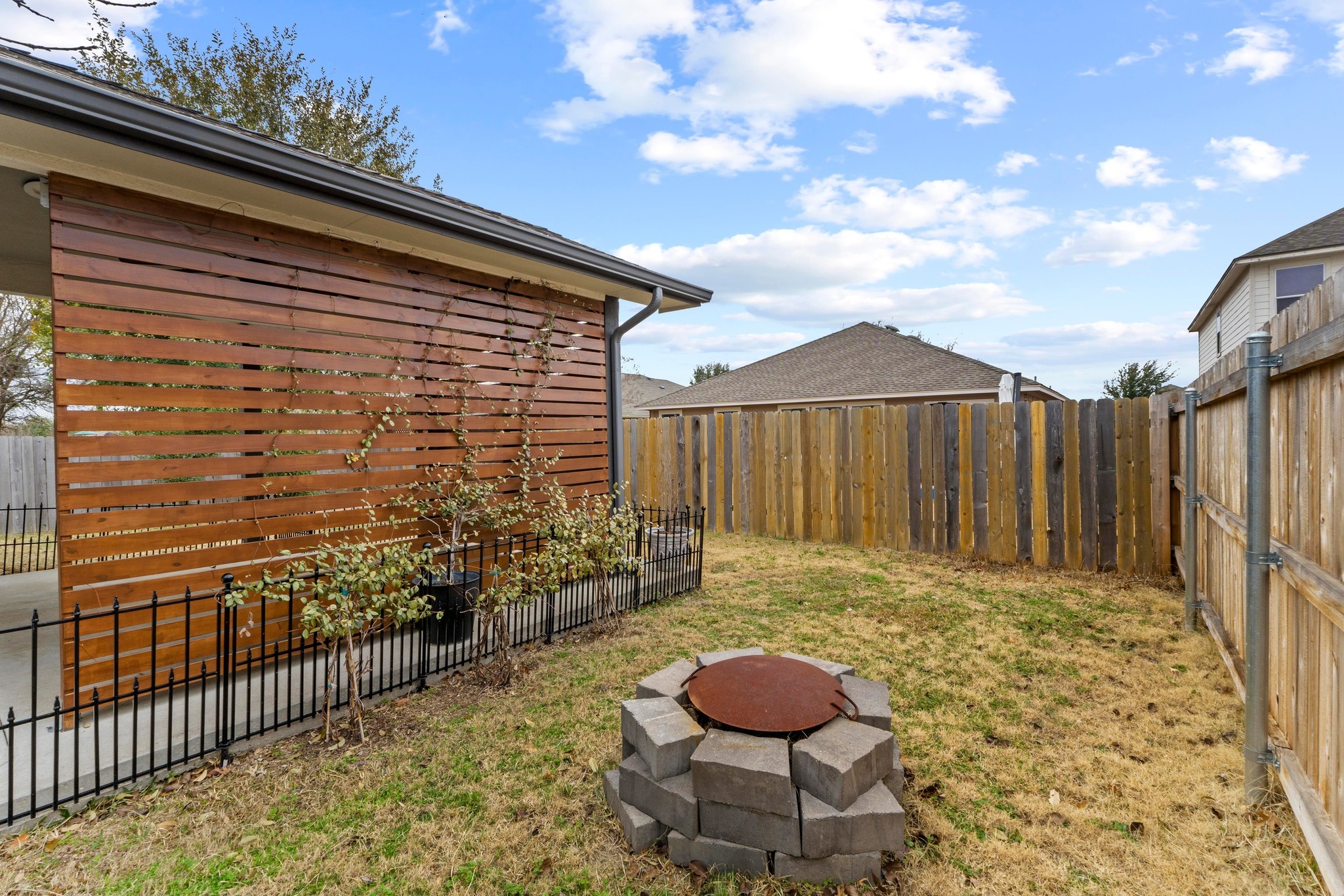 19004 Mangan Way Pflugerville, TX 78660 - Photo 33 of 38 Cozy up on cool evenings by your custom stone fire pit.