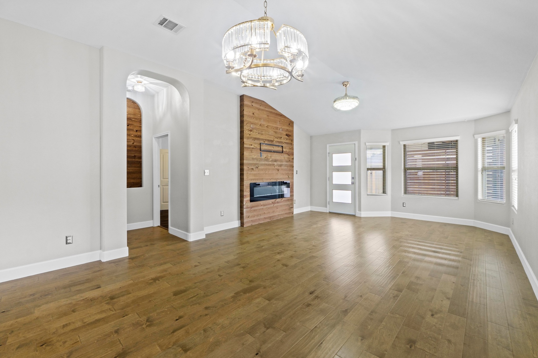 19004 Mangan Way Pflugerville, TX 78660 - Photo 7 of 38 High ceilings and arched doorways add architectural interest and modern light fixtures make this a sophisticated living space.