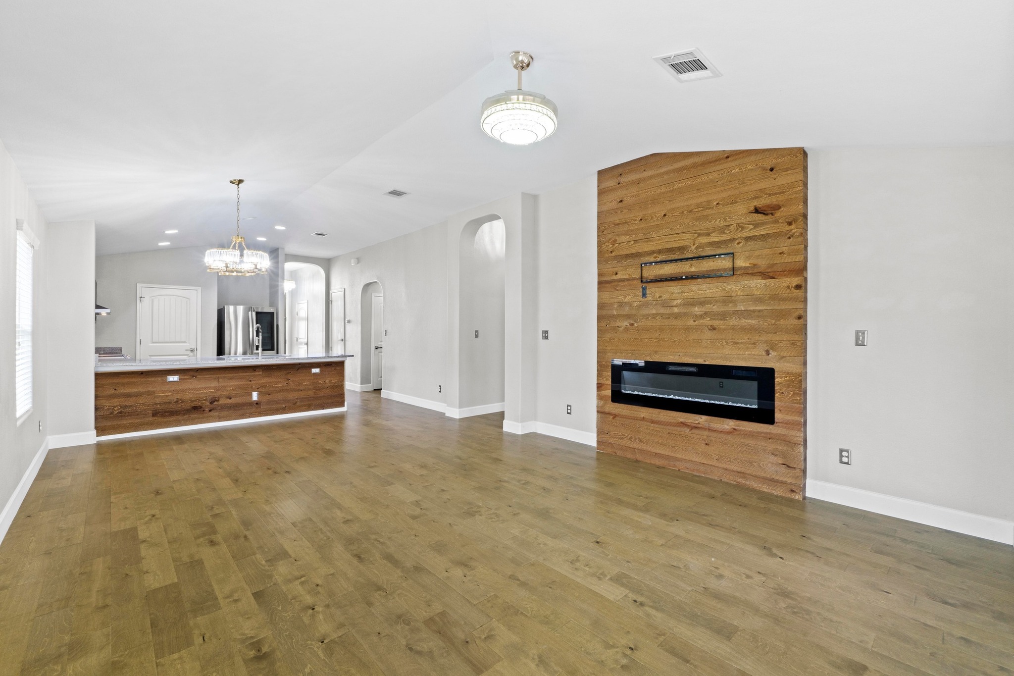 19004 Mangan Way Pflugerville, TX 78660 - Photo 9 of 38 The special details of this home from the wood accents to the modern light fixtures create a warm inviting space to relax in.
