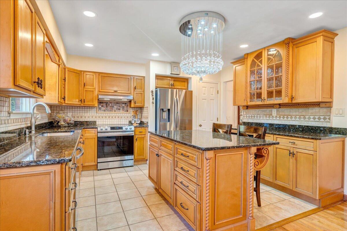 4434 Rosecrest Road Roanoke, VA 24018 - Photo 9 of 48 a kitchen with stainless steel appliances granite countertop a stove top oven a sink dishwasher a dining table and chairs with wooden floor