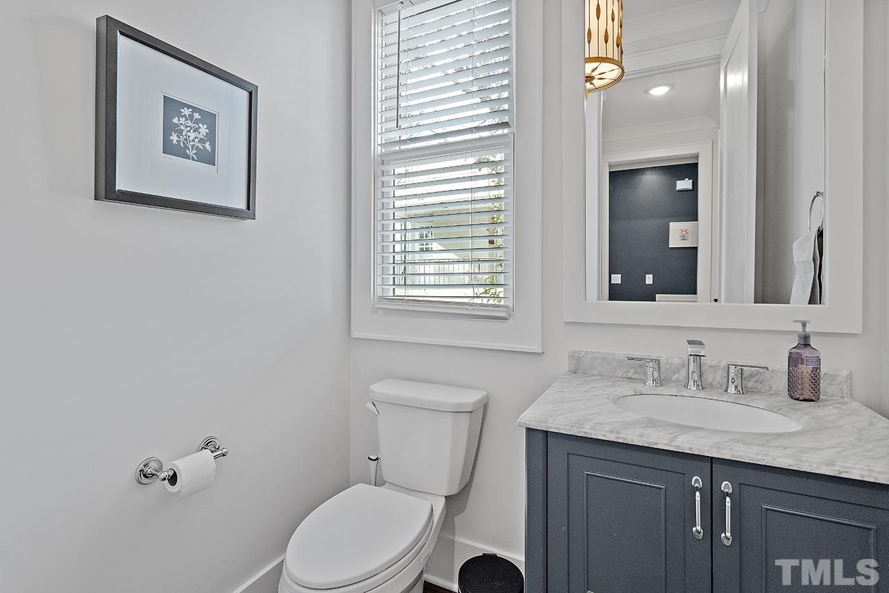 3025 Lewis Farm Road Raleigh, NC 27607 - Photo 12 of 42 a bathroom with a granite countertop toilet sink and mirror