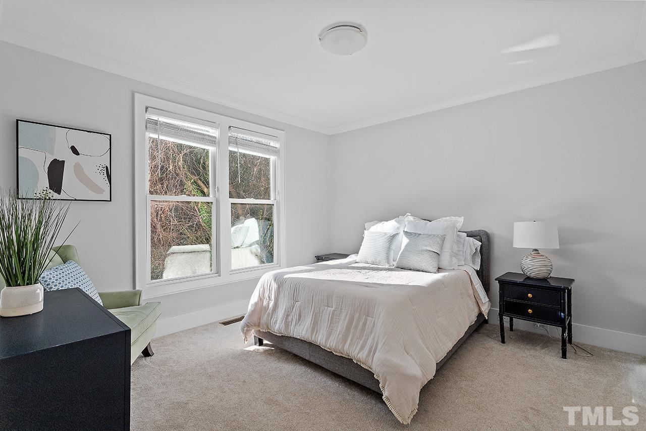 3025 Lewis Farm Road Raleigh, NC 27607 - Photo 15 of 42 a bedroom with a bed table and window