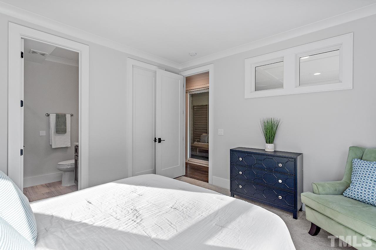 3025 Lewis Farm Road Raleigh, NC 27607 - Photo 16 of 42 a bedroom with a bed and a dresser