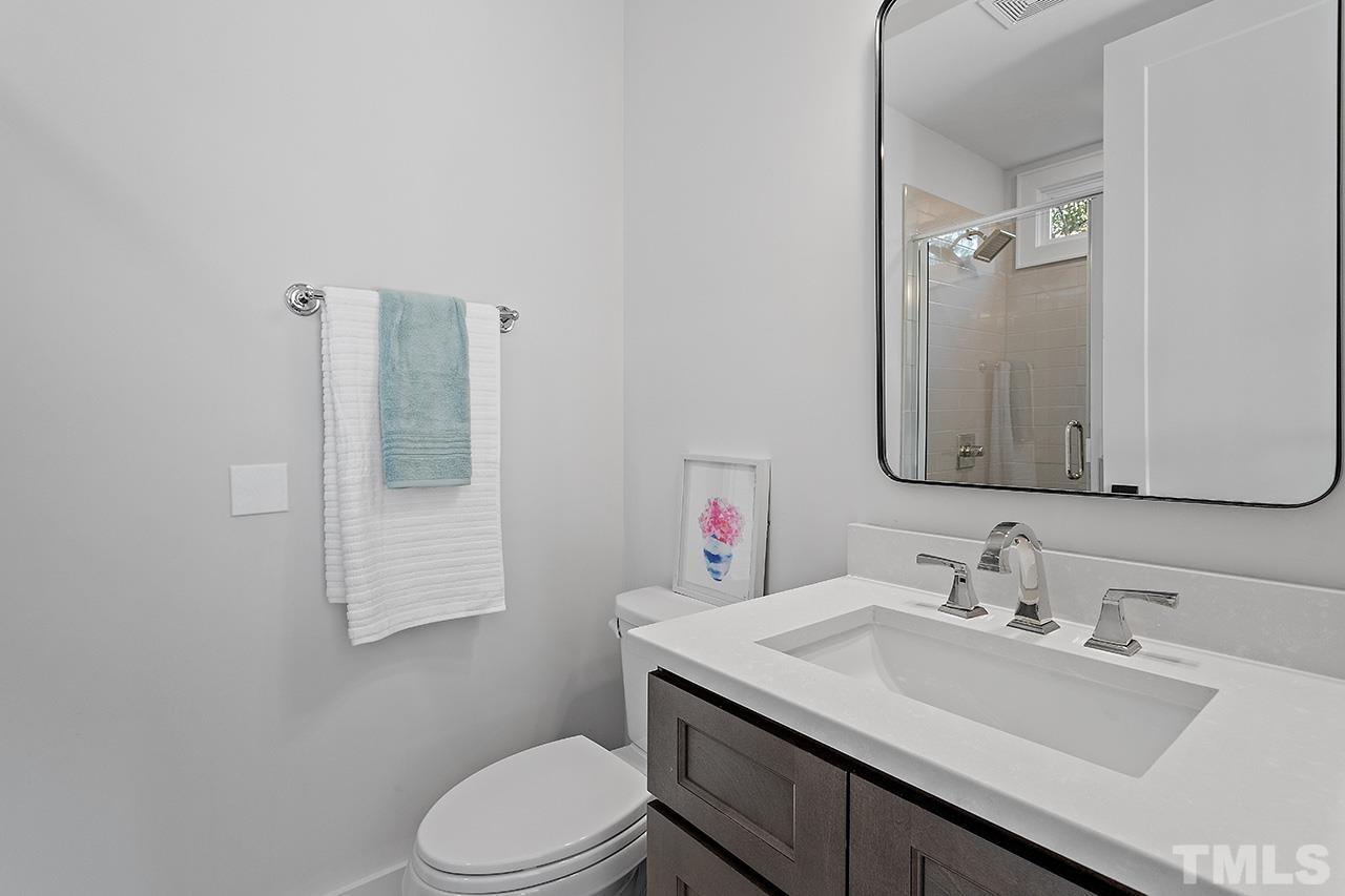 3025 Lewis Farm Road Raleigh, NC 27607 - Photo 17 of 42 a bathroom with a sink vanity mirror and toilet