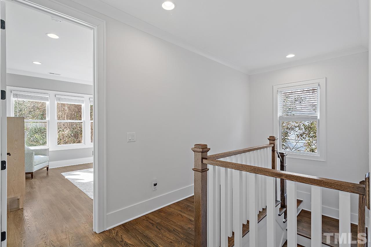 3025 Lewis Farm Road Raleigh, NC 27607 - Photo 19 of 42 a view of a hallway with a window and wooden floor