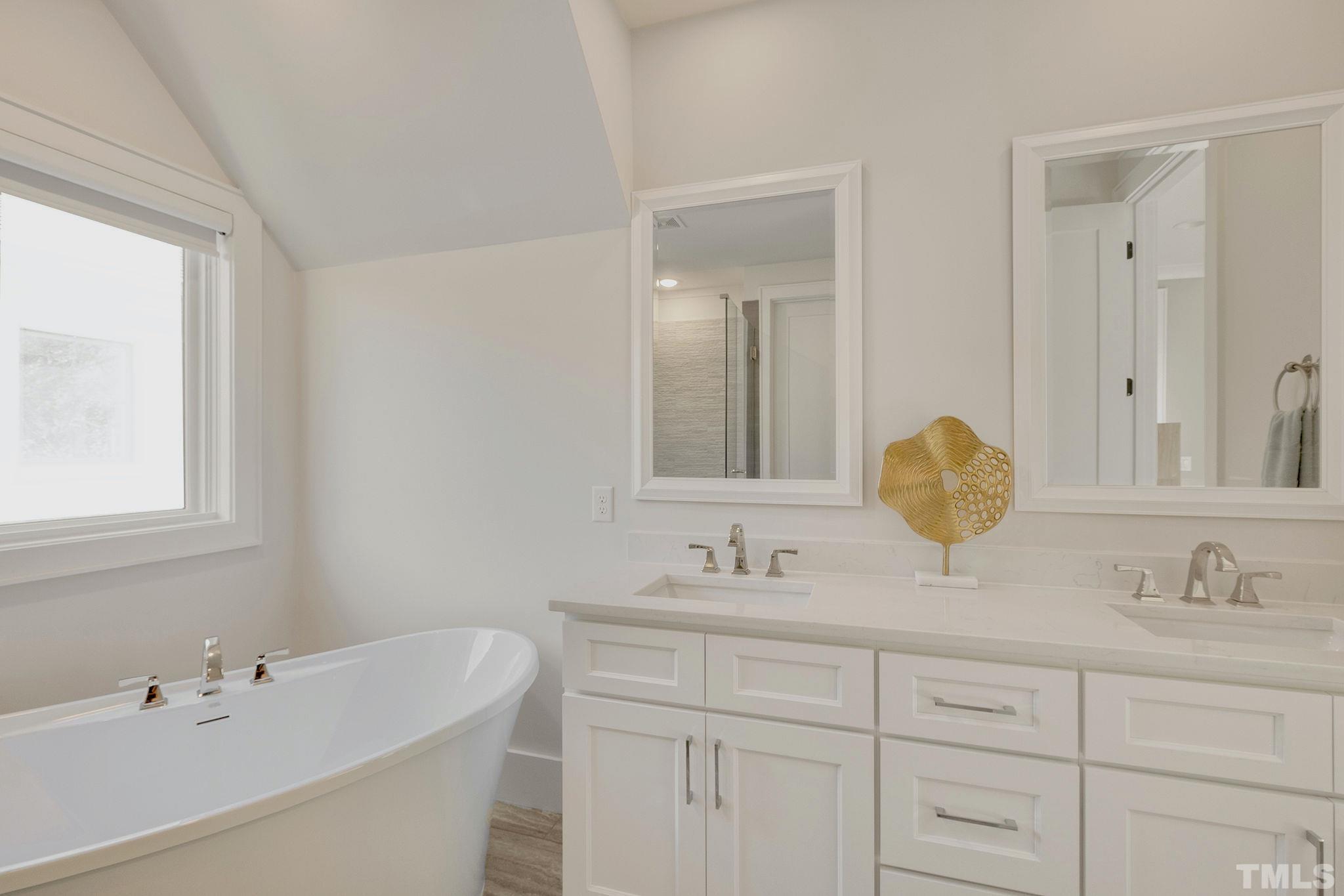 3025 Lewis Farm Road Raleigh, NC 27607 - Photo 21 of 42 a bathroom with a sink vanity and mirror