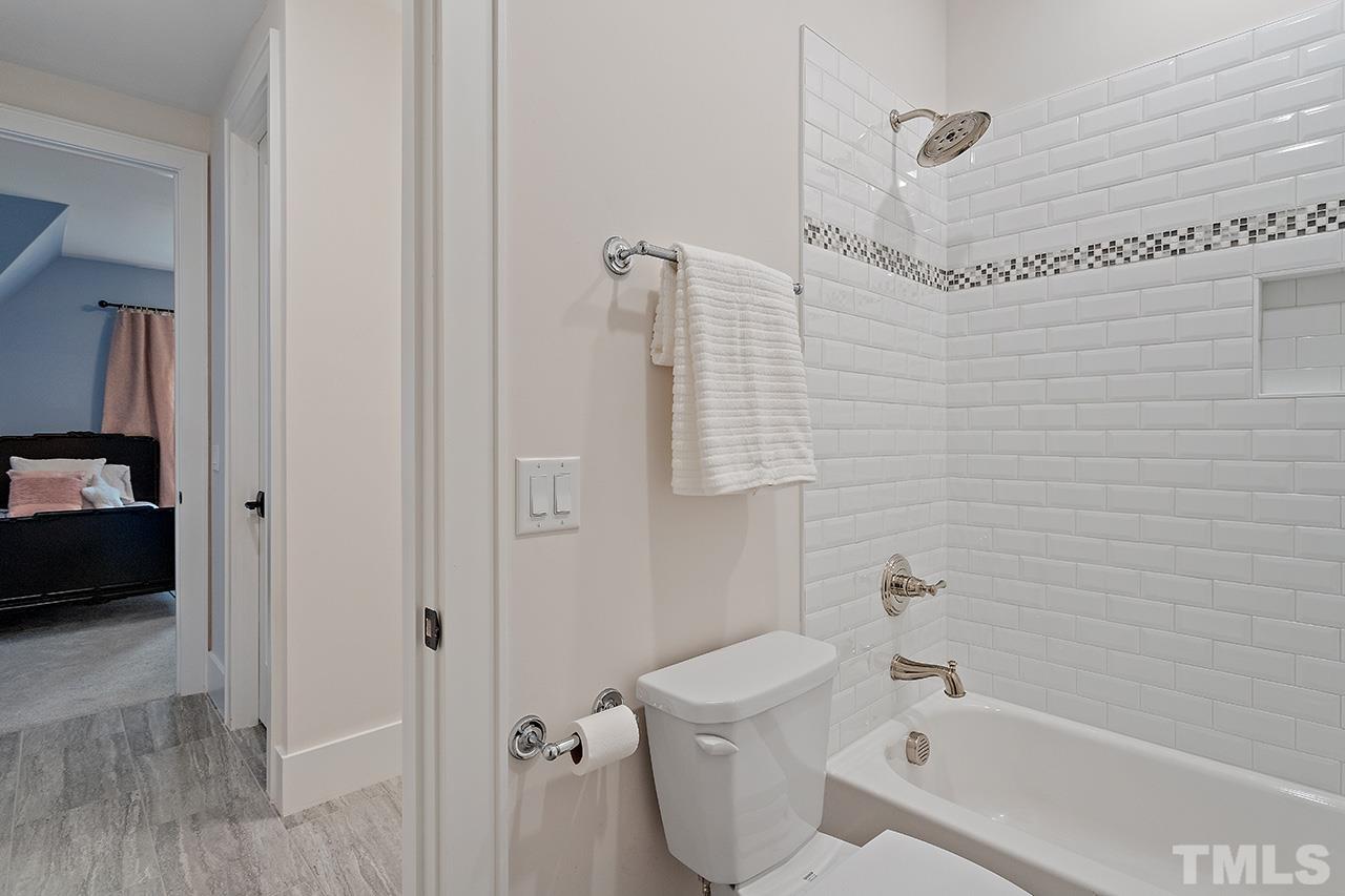 3025 Lewis Farm Road Raleigh, NC 27607 - Photo 28 of 42 a bathroom with a bathtub a sink and a shower