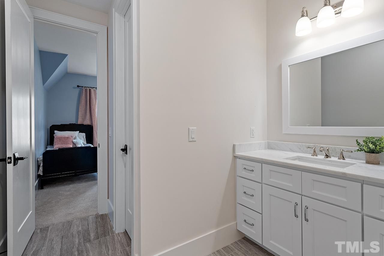3025 Lewis Farm Road Raleigh, NC 27607 - Photo 29 of 42 a en suite bathroom with a sink double vanity and a mirror