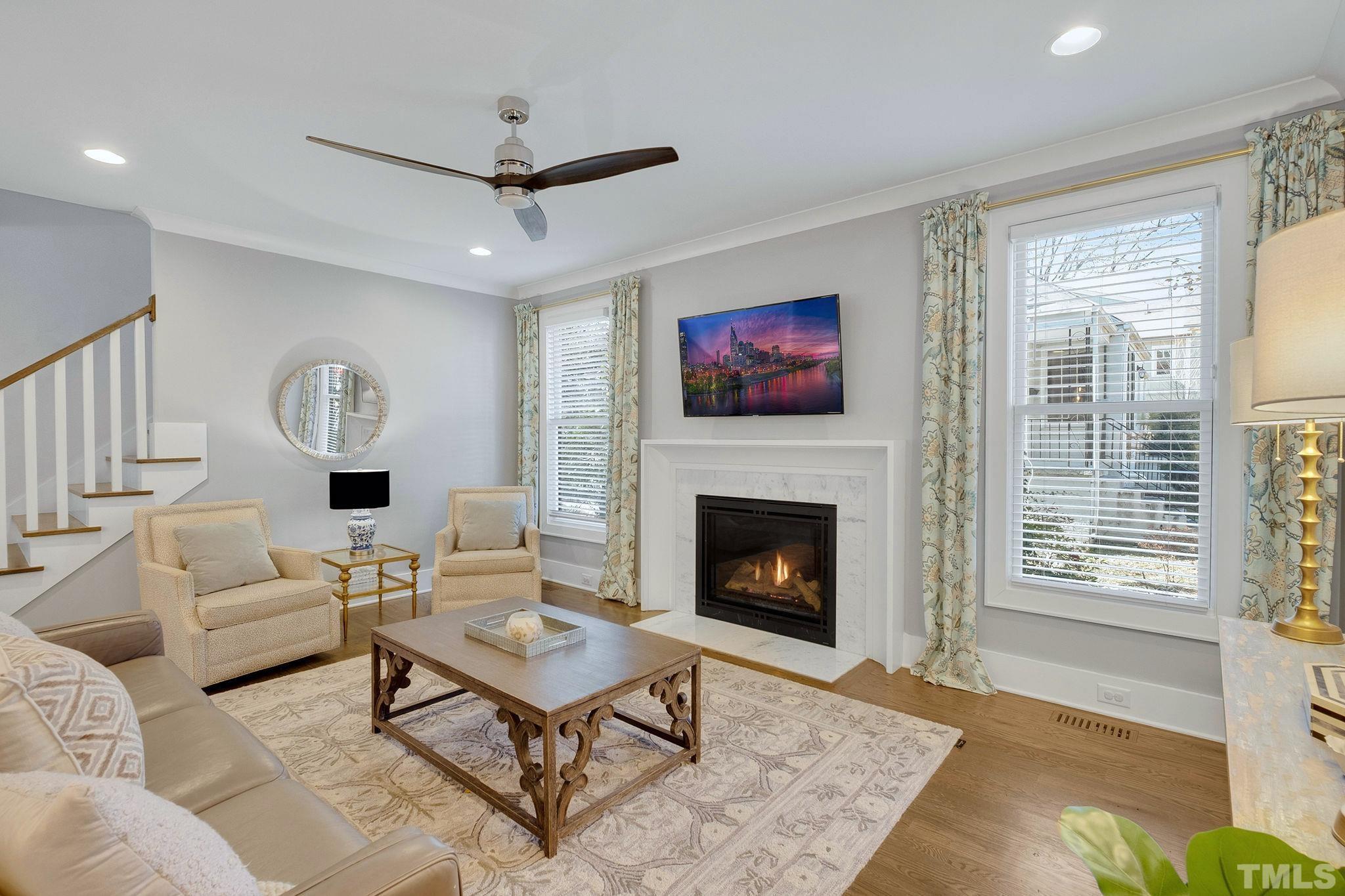 3025 Lewis Farm Road Raleigh, NC 27607 - Photo 9 of 42 a living room with furniture a rug and a fireplace