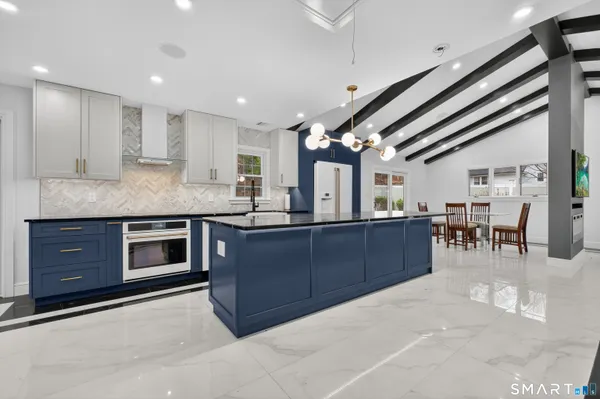 a kitchen with stainless steel appliances granite countertop a stove and cabinets