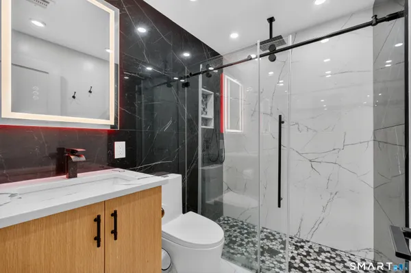a bathroom with a sink toilet and shower