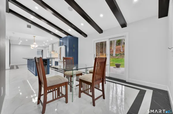 a view of a dining room with furniture and a floor to ceiling window