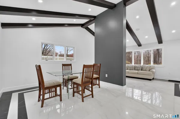 a view of a dining room with furniture and a large window