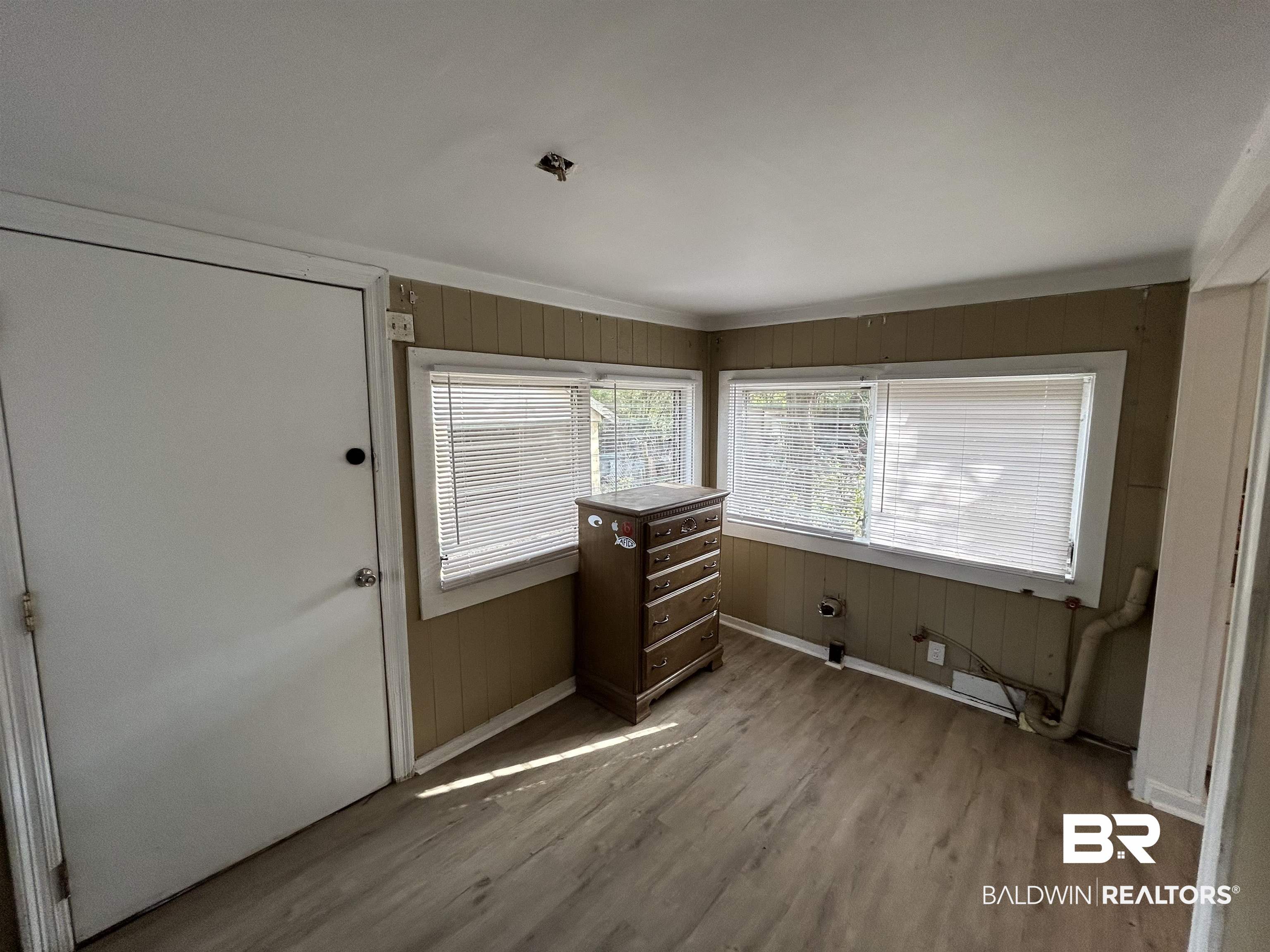 2119 Hoppin Street Mobile, AL 36605 - Photo 13 of 23 Interior space featuring light wood-type flooring and wooden walls