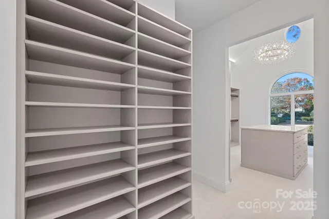 a view of walk in closet with empty racks