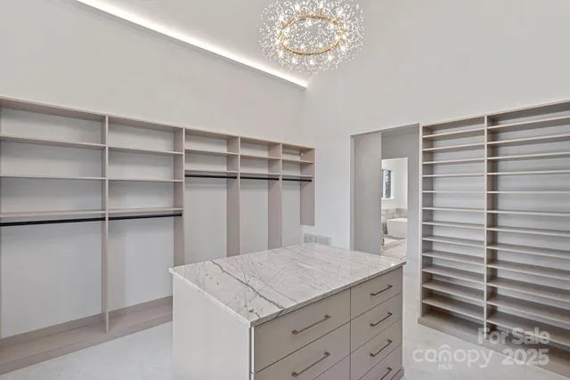 a kitchen with a cabinets and chandelier