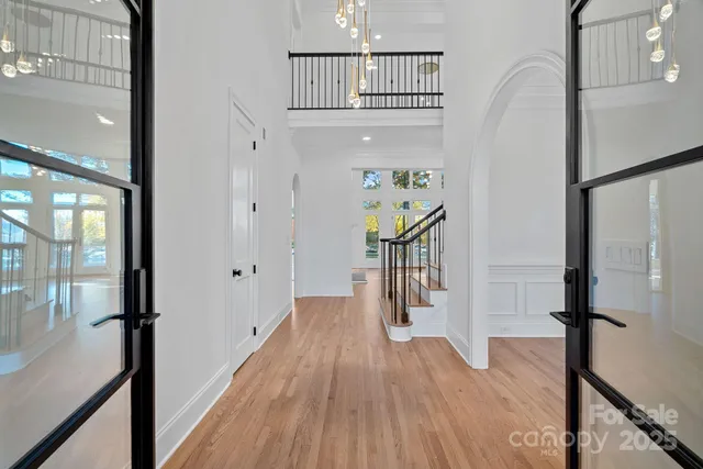 a view of a hallway view with wooden floor and staircase